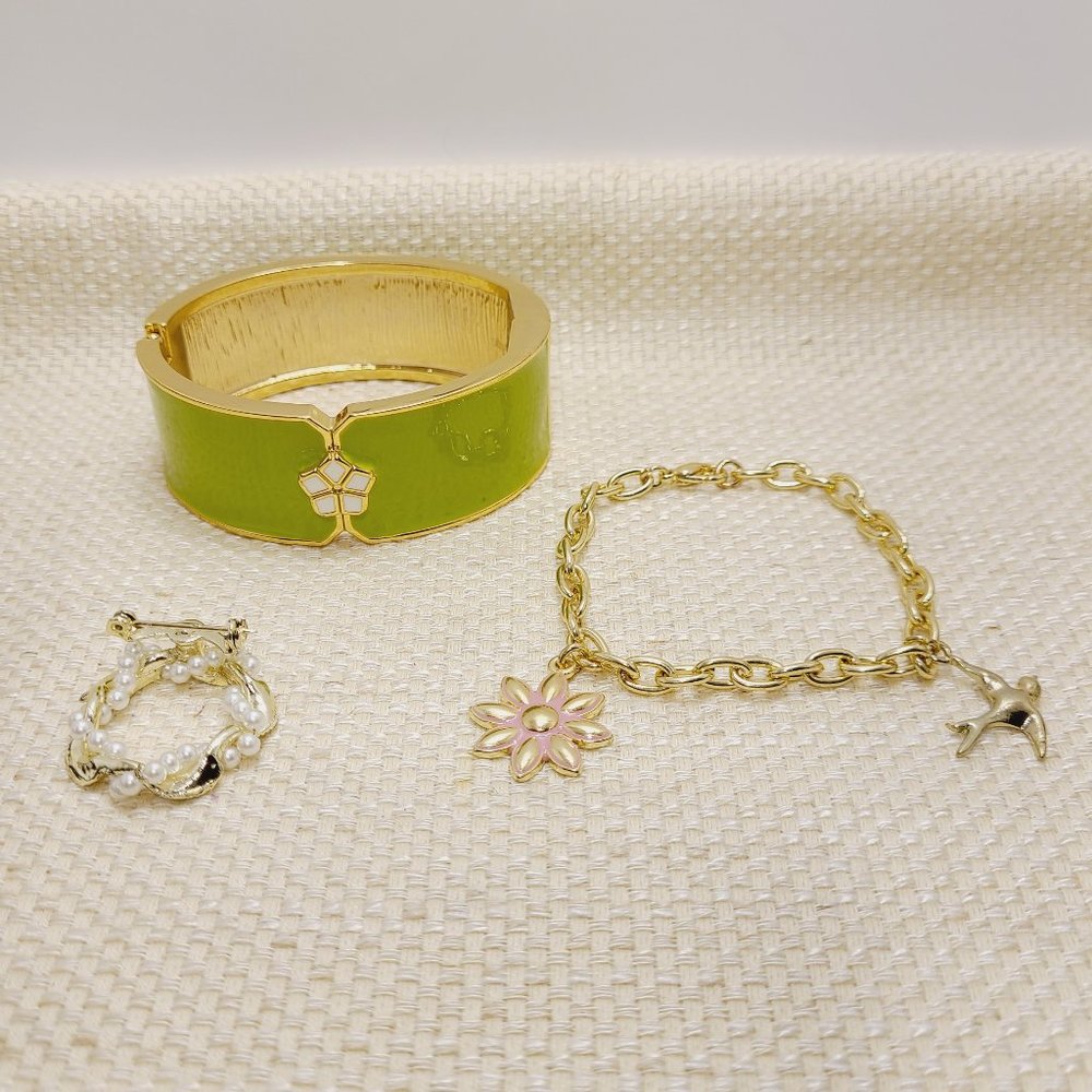 Set of 3 matching gold tone bracelets and brooch.